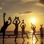 Happy family standing on the beach