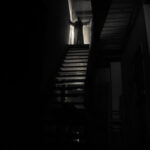 113455395-inside-of-old-creepy-abandoned-mansion-silhouette-of-horror-ghost-standing-on-castle-stairs-to-the-b
